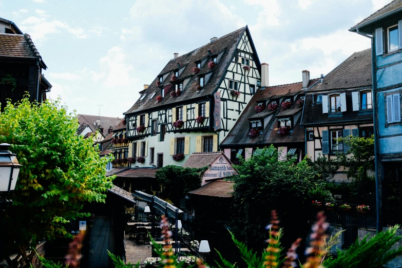 a couple of buildings that are next to each other, a photo, by Julia Pishtar, pexels contest winner, renaissance, french village exterior, 🦩🪐🐞👩🏻🦳, black forest, music video