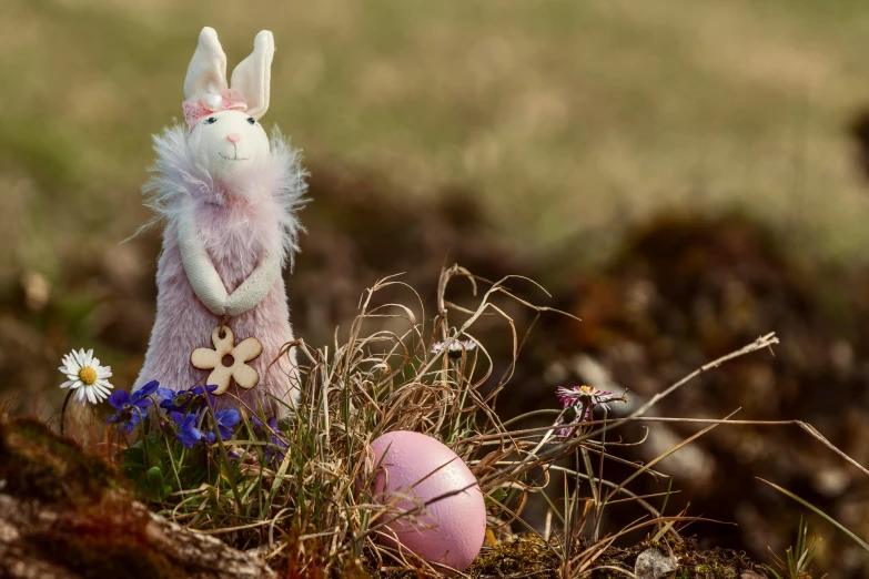 a stuffed bunny sitting on top of a pile of grass, pixabay contest winner, figuration libre, pink, taken with sony alpha 9, faberge, rustic