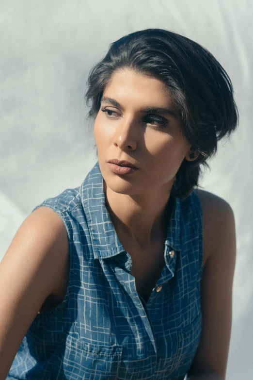 a beautiful young woman sitting on top of a skateboard, trending on unsplash, renaissance, blue shirt, morena baccarin, androgynous face, wearing a plaid shirt