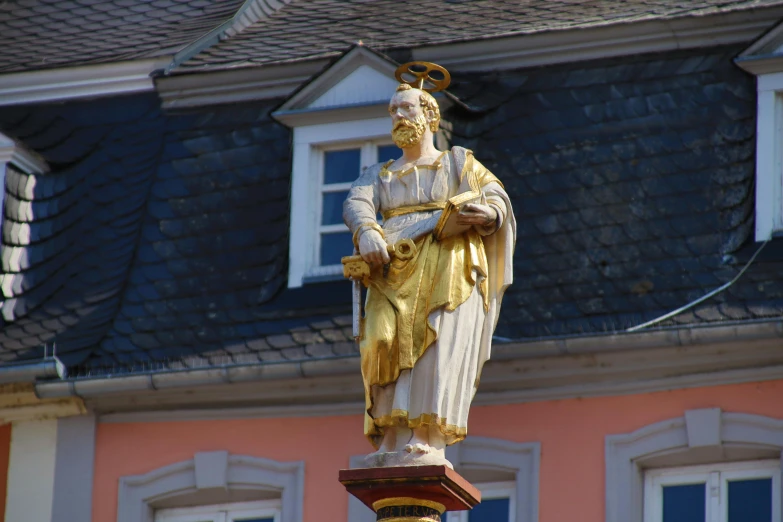 a statue of jesus on top of a building, a statue, by Joseph von Führich, pexels, baroque, pink and gold color scheme, detmold, with yellow cloths, avatar image