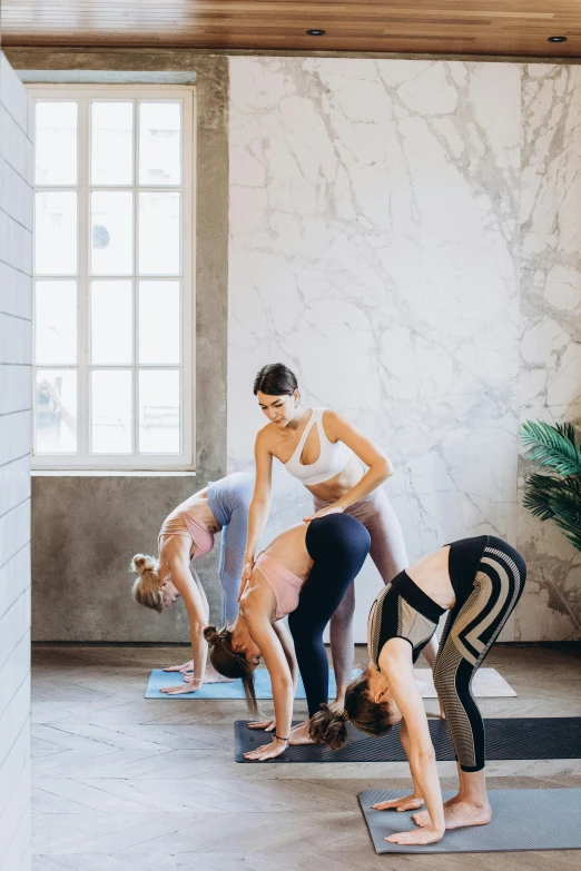 a group of people doing yoga in a room, trending on pexels, renaissance, woman holding another woman, back arched, all marble, curated collections