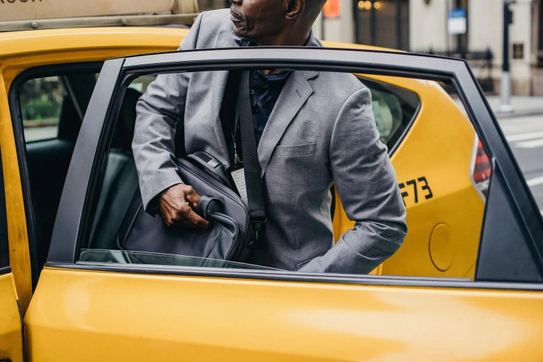 a man in a suit getting out of a taxi, by Carey Morris, wearing nanotech honeycomb robe, gray canvas, thumbnail, detail shot