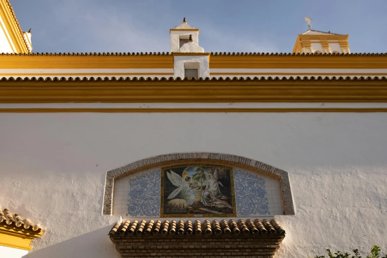 a clock mounted to the side of a white building, a mosaic, inspired by Luis Paret y Alcazar, religión, ocher, marbella, wide angel shot from below