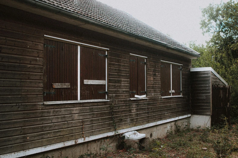 an old run down house with boarded windows, unsplash, barbizon school, 90s photo, wooden toilets, pavilion, ((rust))