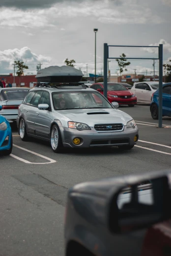 a group of cars parked in a parking lot, by Sven Erixson, reddit, subaru, casually dressed, low quality photo
