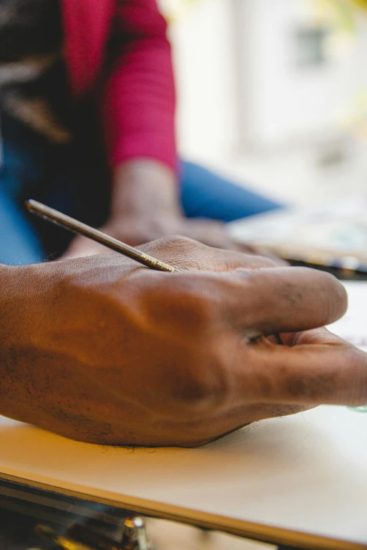 a close up of a person writing on a piece of paper, a photorealistic painting, pexels contest winner, sleek hands, oil pastels and gold, india ink, pencil drawing of mkbhd