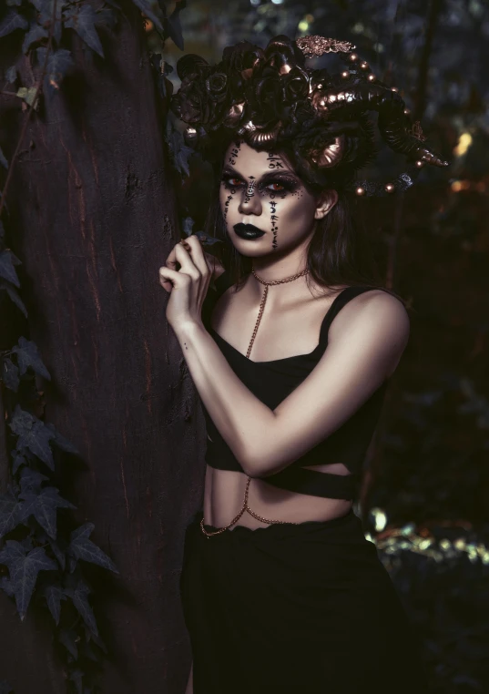 a woman with black makeup standing next to a tree, inspired by Elsa Bleda, pexels contest winner, gothic art, rose crown, (night), beautiful frankenstein, low quality photograph