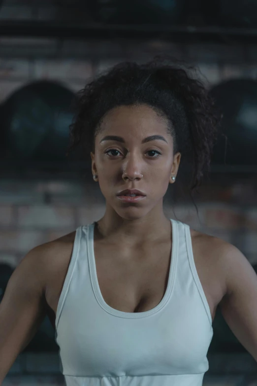 a woman holding a tennis racquet in a gym, inspired by Jessie Alexandra Dick, ashteroth, ( ( theatrical ) ), headshot, commercial