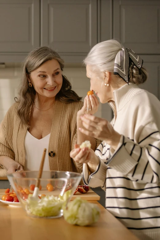 two women in a kitchen preparing food together, pexels contest winner, gray haired, avatar image, fall season, having a snack