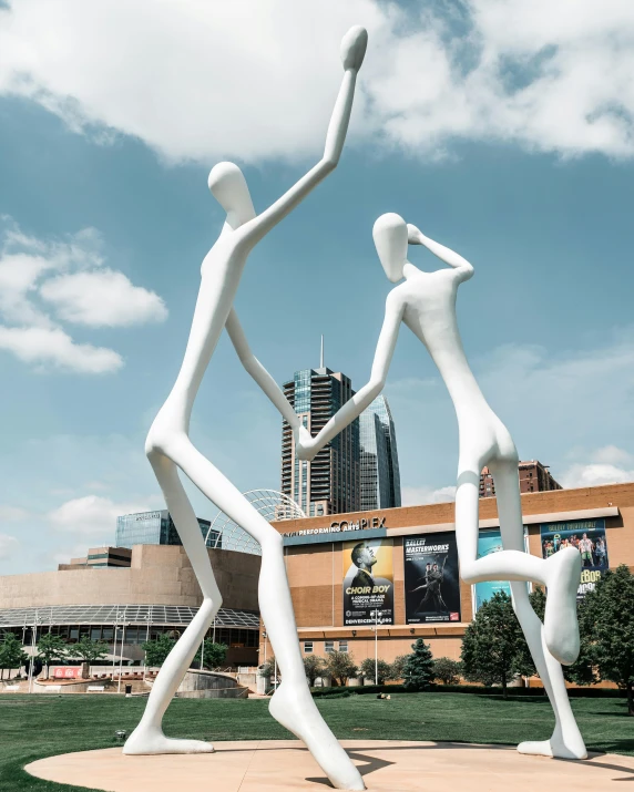 a couple of statues standing on top of a lush green field, inspired by Alexander Archipenko, unsplash contest winner, new sculpture, urban plaza, photograph of three ravers, made out of shiny white metal, lgbt art