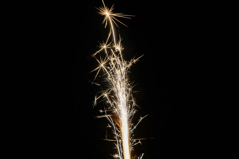 a sparkler is lit up in the dark, a stipple, by Thomas Häfner, unsplash, shiny silver, booster flares, in 2 0 1 2, gold