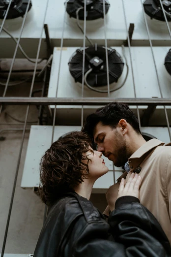 a man and woman standing next to each other in front of a building, inspired by Elsa Bleda, pexels contest winner, lesbian kiss, curls, 256435456k film, low quality photo