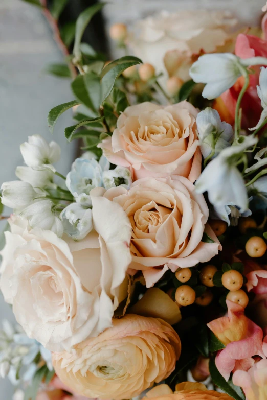 a close up of a bouquet of flowers on a table, by Kristin Nelson, romanticism, caramel. rugged, pastel roses, smooth details, slightly smooth