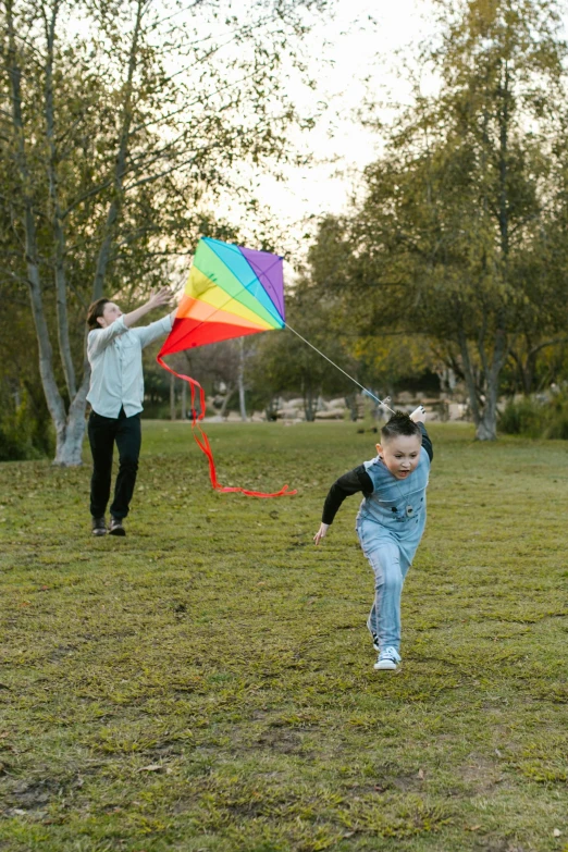 a young child running with a kite in a park, by Samuel Scott, pexels, conceptual art, lgbtq, color ( sony a 7 r iv, wide scene, families playing