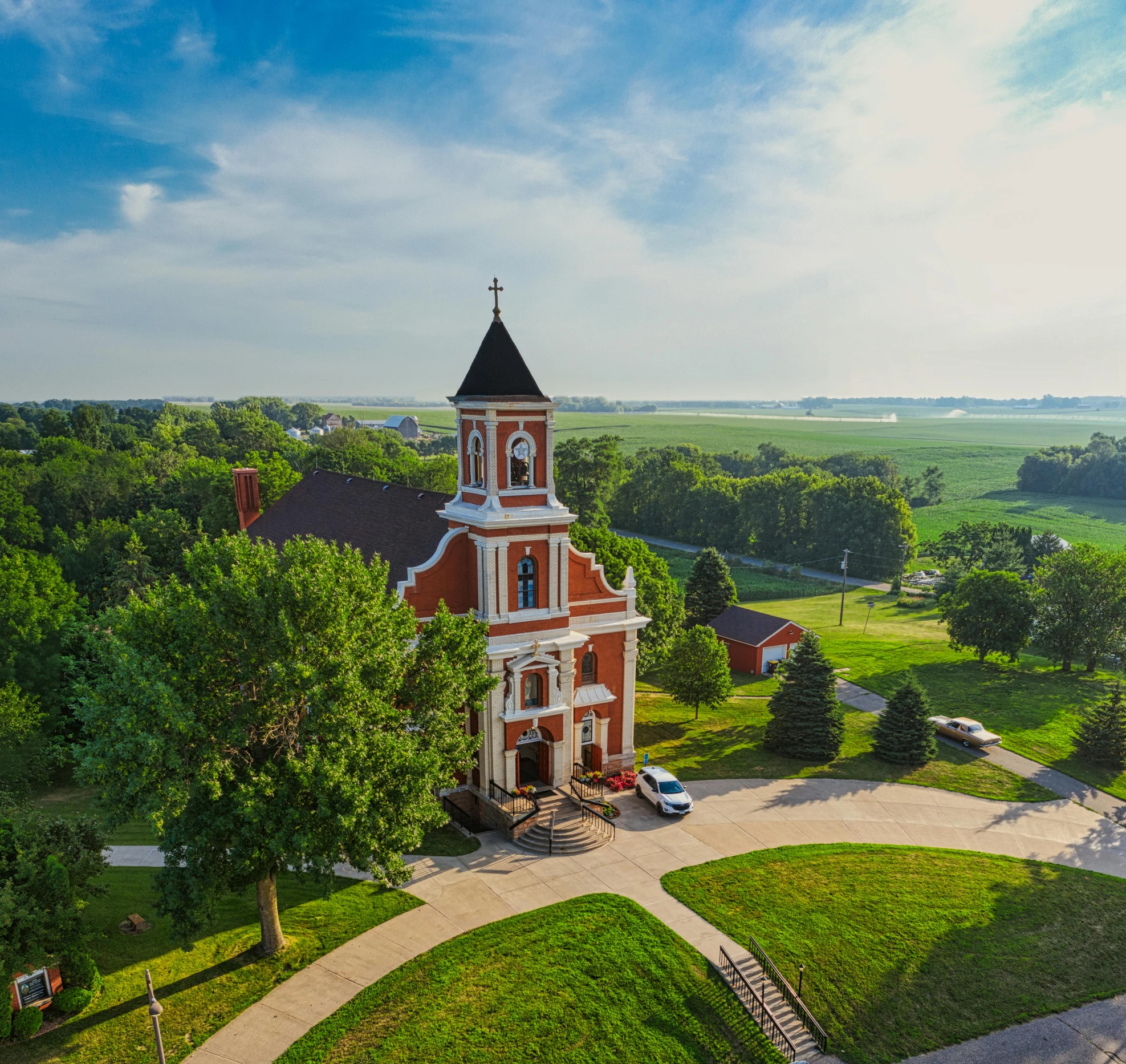 a church sitting on top of a lush green field, a picture, by Robert Storm Petersen, unsplash contest winner, northwest school, iowa, town hall, wide high angle view, background image