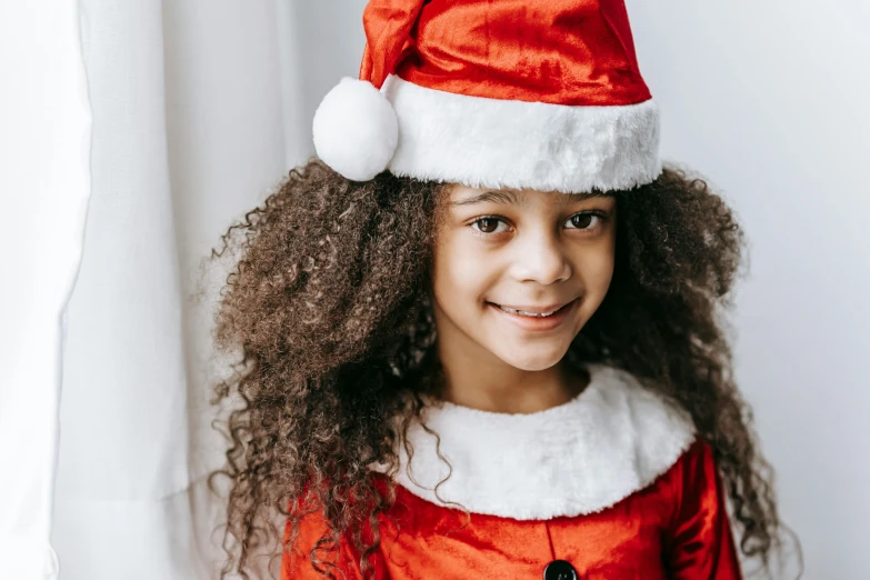 a little girl wearing a santa claus hat, pexels, hurufiyya, a black man with long curly hair, front portrait of a girl, instagram post, the hime cut