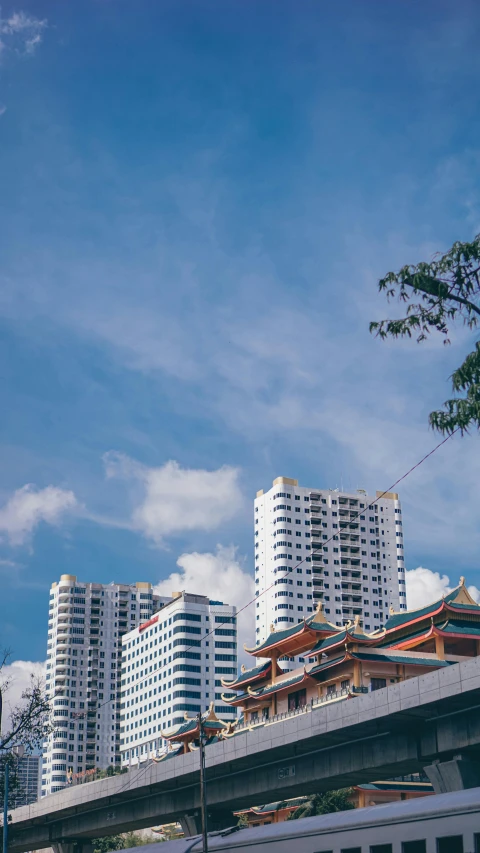 a large long train on a steel track, inspired by Cheng Jiasui, unsplash, minimalism, palms and miami buildings, chinese temple, panorama view of the sky, square