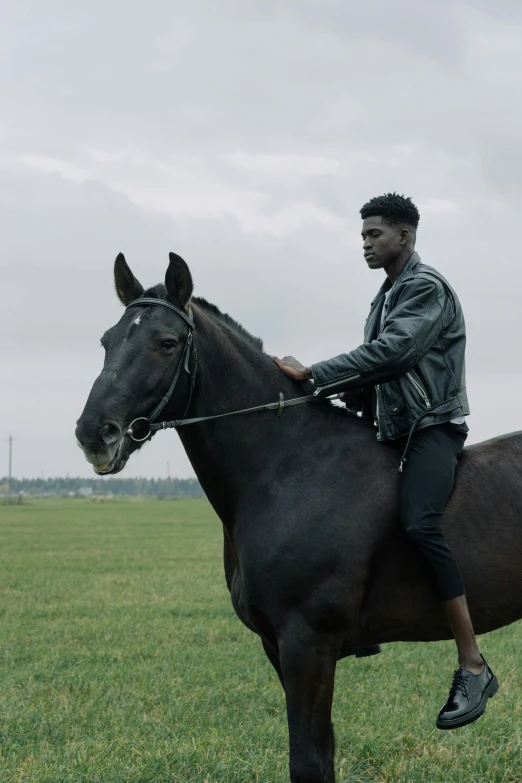 a man riding on the back of a black horse, an album cover, trending on unsplash, black teenage boy, movie still, denmark, grey skinned