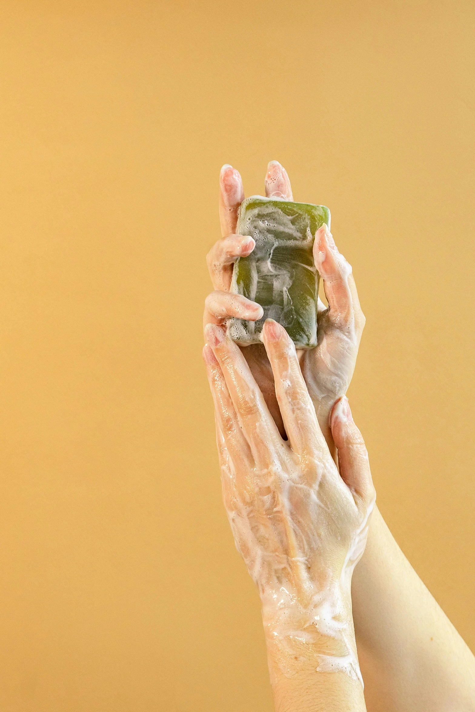 a person is washing their hands with soap, a picture, by Andries Stock, shutterstock, with seaweed, square, photoshoot for skincare brand, jelly - like texture