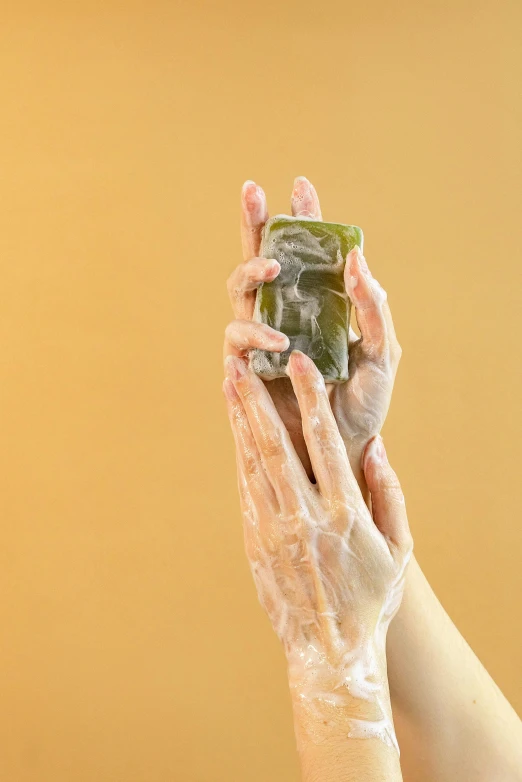 a person is washing their hands with soap, a picture, by Andries Stock, shutterstock, with seaweed, square, photoshoot for skincare brand, jelly - like texture