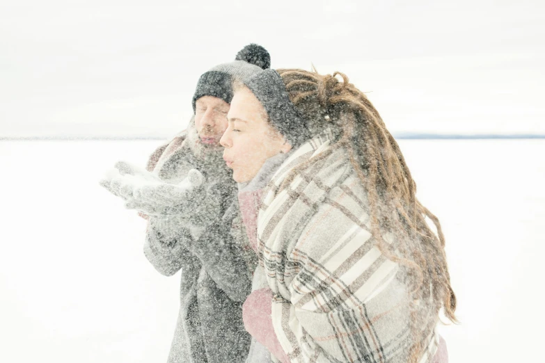 a man and a woman standing in the snow, an album cover, by Jaakko Mattila, pexels contest winner, hair blowing the wind, picnic, frozen lake, profile image