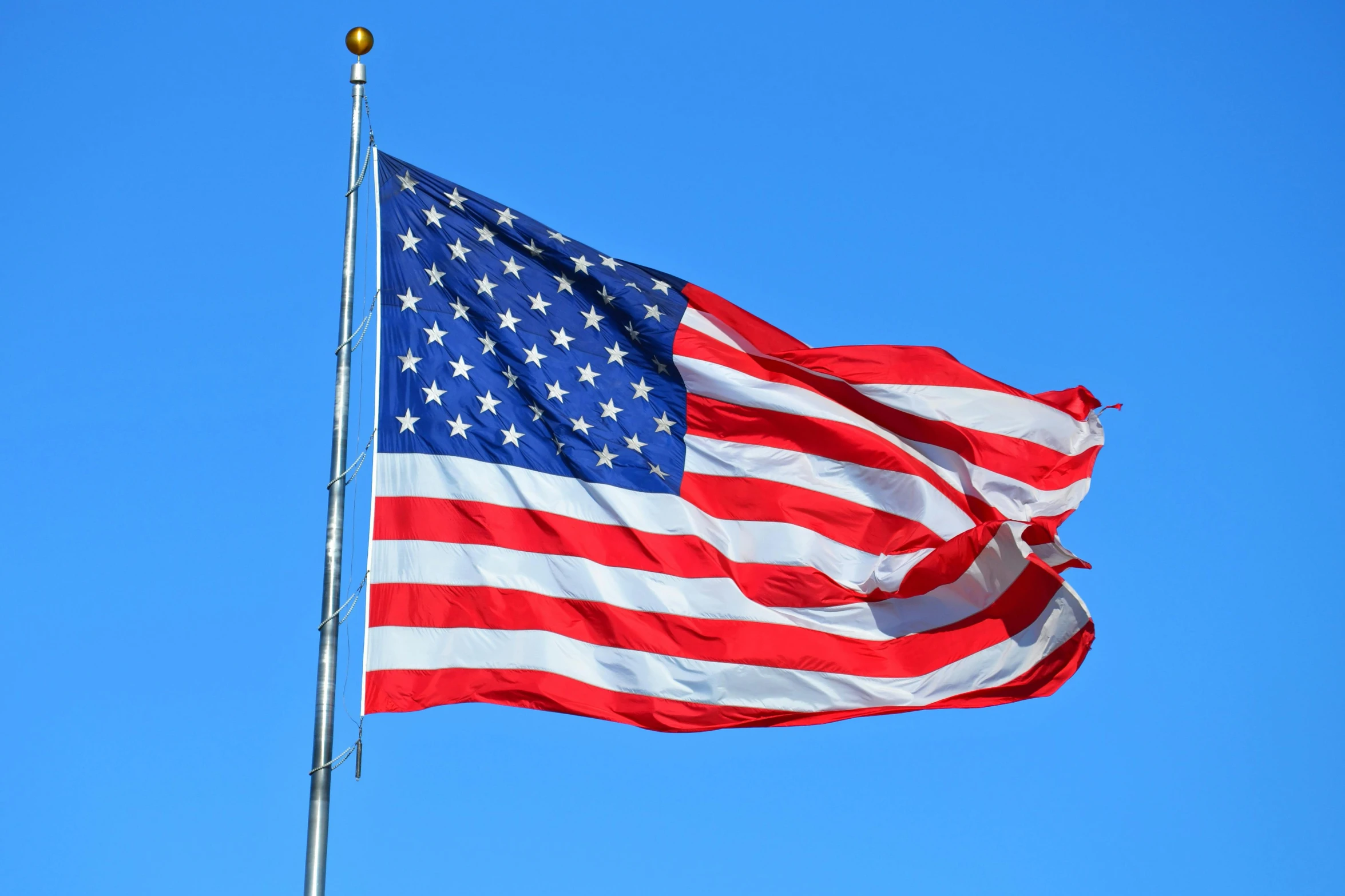 an american flag blowing in the wind against a blue sky, a portrait, pexels, hurufiyya, 2 5 6 x 2 5 6 pixels, various posed, an intricate, vga