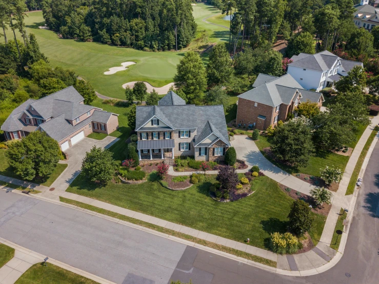 an aerial view of a home with a golf course in the background, cg society contest winner, listing image, lawns, shot from roofline, well maintained