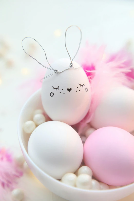 a white bowl filled with pink and white eggs, inspired by Peter Alexander Hay, trending on pexels, sanrio ornaments, feather hair ornaments, close face view, bunny