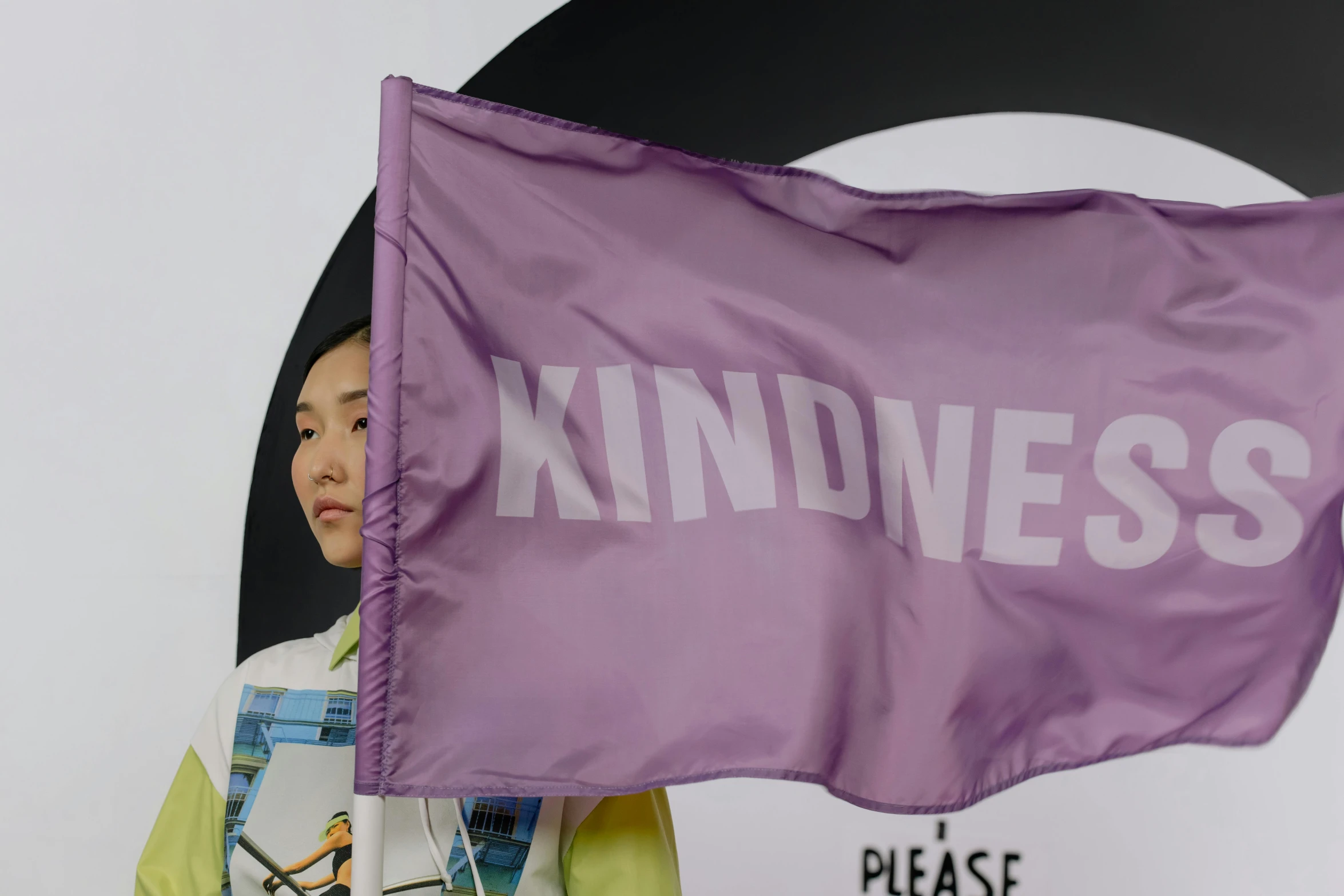 a woman holding a purple flag that says kindness, a picture, showstudio, cai xukun, kids place, offwhite