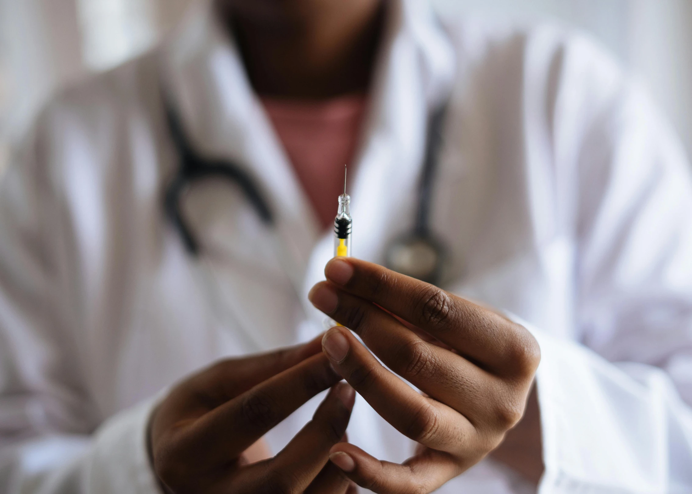 a person with a stethoscope in their hand, a picture, unsplash, holding syringe, multiple stories, brown, lgbtq