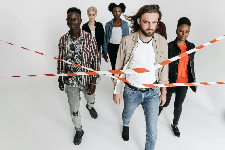 a group of people standing next to each other, by Matija Jama, pexels contest winner, antipodeans, offwhite, crossing the line, plain background, aboriginal australian hipster