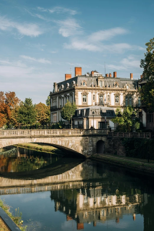 a bridge over a river with a building in the background, inspired by Stanislas Lépine, pexels contest winner, renaissance, in the autumn, square, mansion, rennes - le - chateau