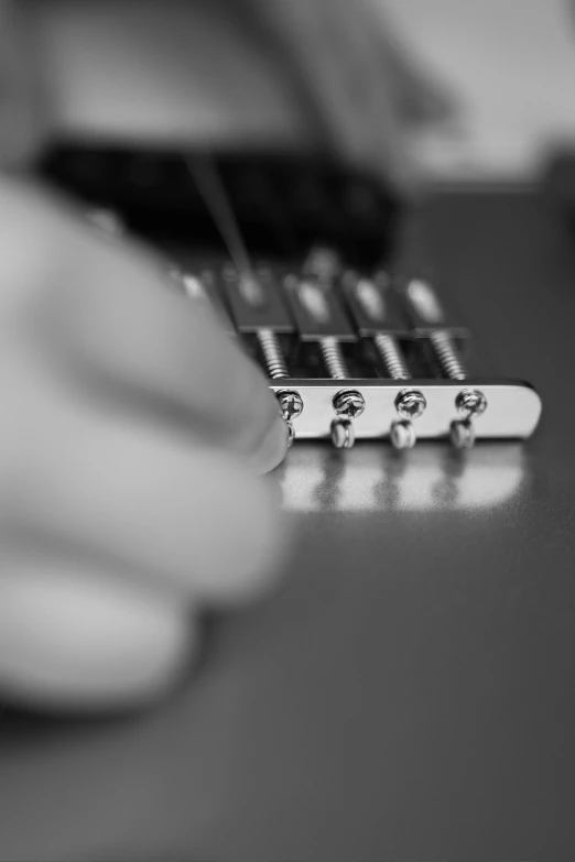 a close up of a person playing a guitar, by Mathias Kollros, precision detail, uploaded, hardware, back and white