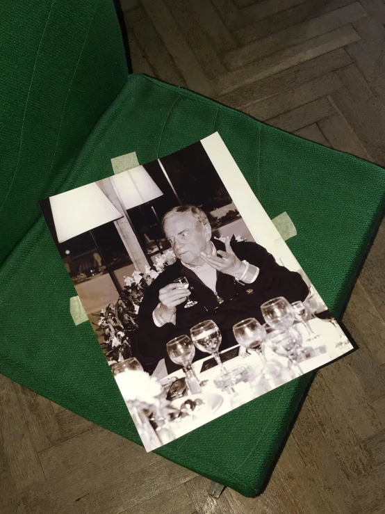 a picture of a man and a woman sitting at a table, a polaroid photo, by Anato Finnstark, unsplash, fluxus, wearing green suit, viktor orban drinking champagne, auction catalogue photo, 1978 cut out collage