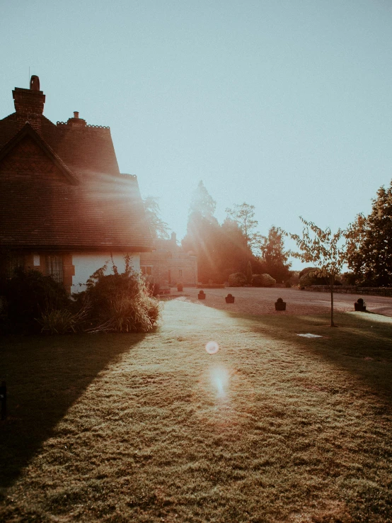 a house sitting on top of a lush green field, by Matthew Smith, pexels contest winner, arts and crafts movement, sunset. light shadow, cottage close up, sunfaded, high quality image