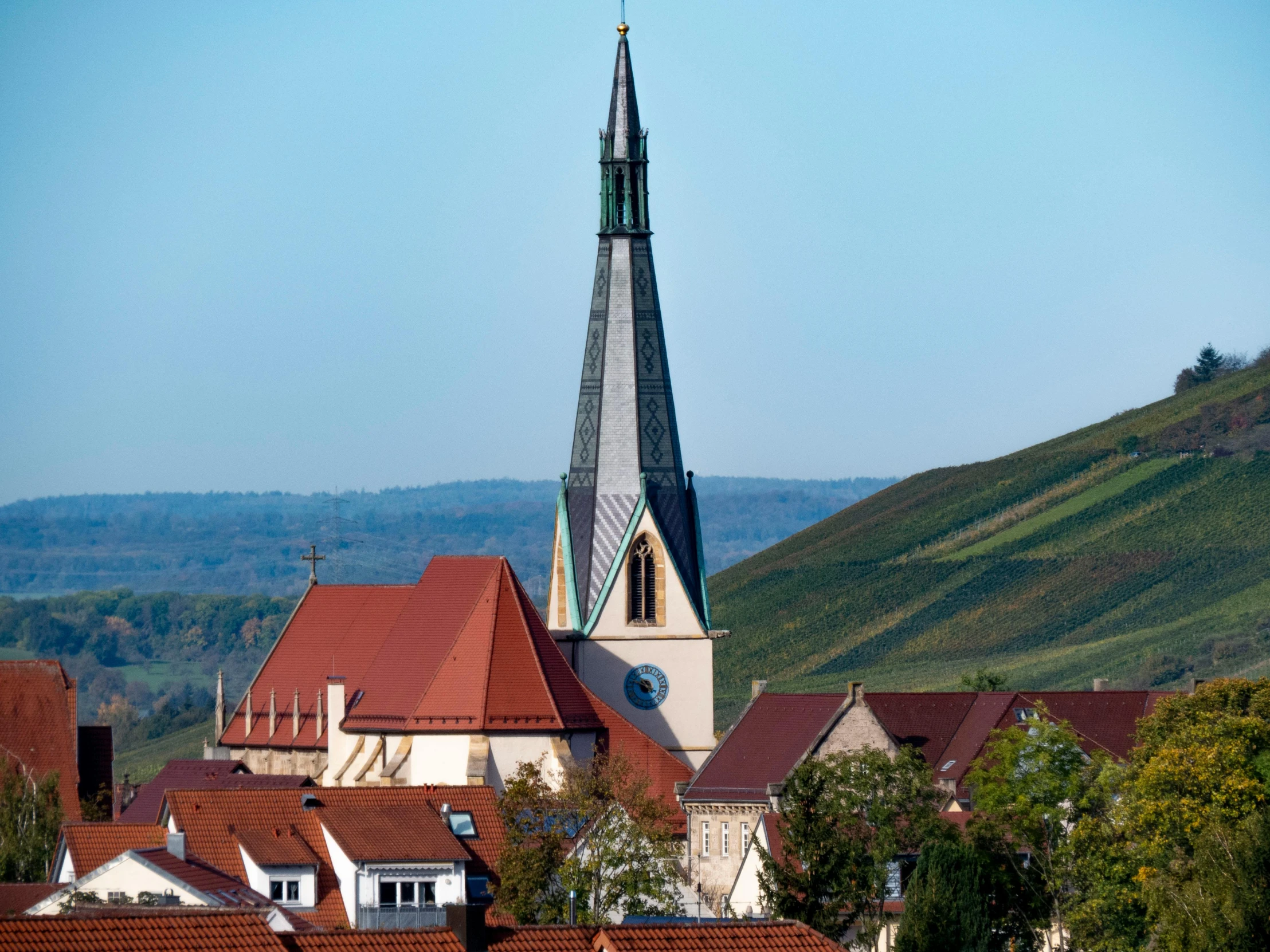 a large building with a steeple on top of it, by Ulrich Leman, pexels contest winner, with rolling hills, pur champagne damery, tiny village, slide show