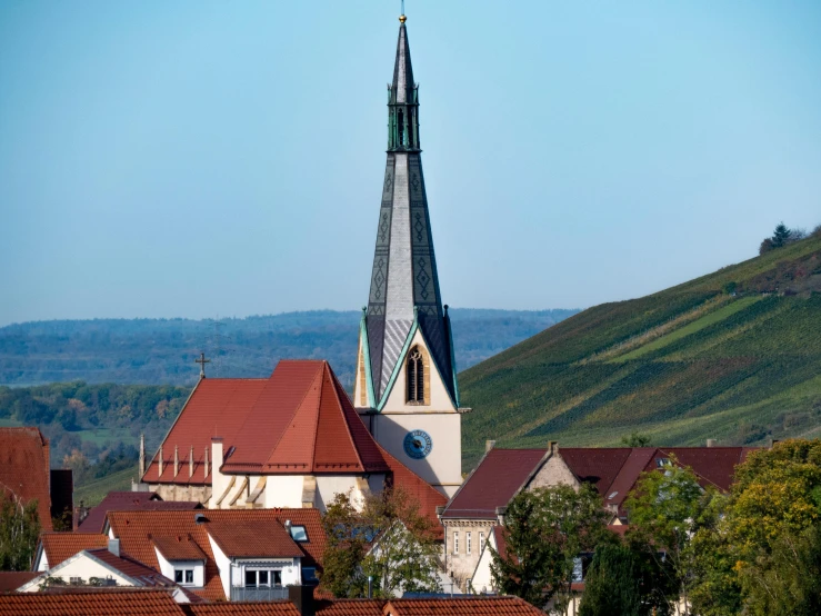 a large building with a steeple on top of it, by Ulrich Leman, pexels contest winner, with rolling hills, pur champagne damery, tiny village, slide show