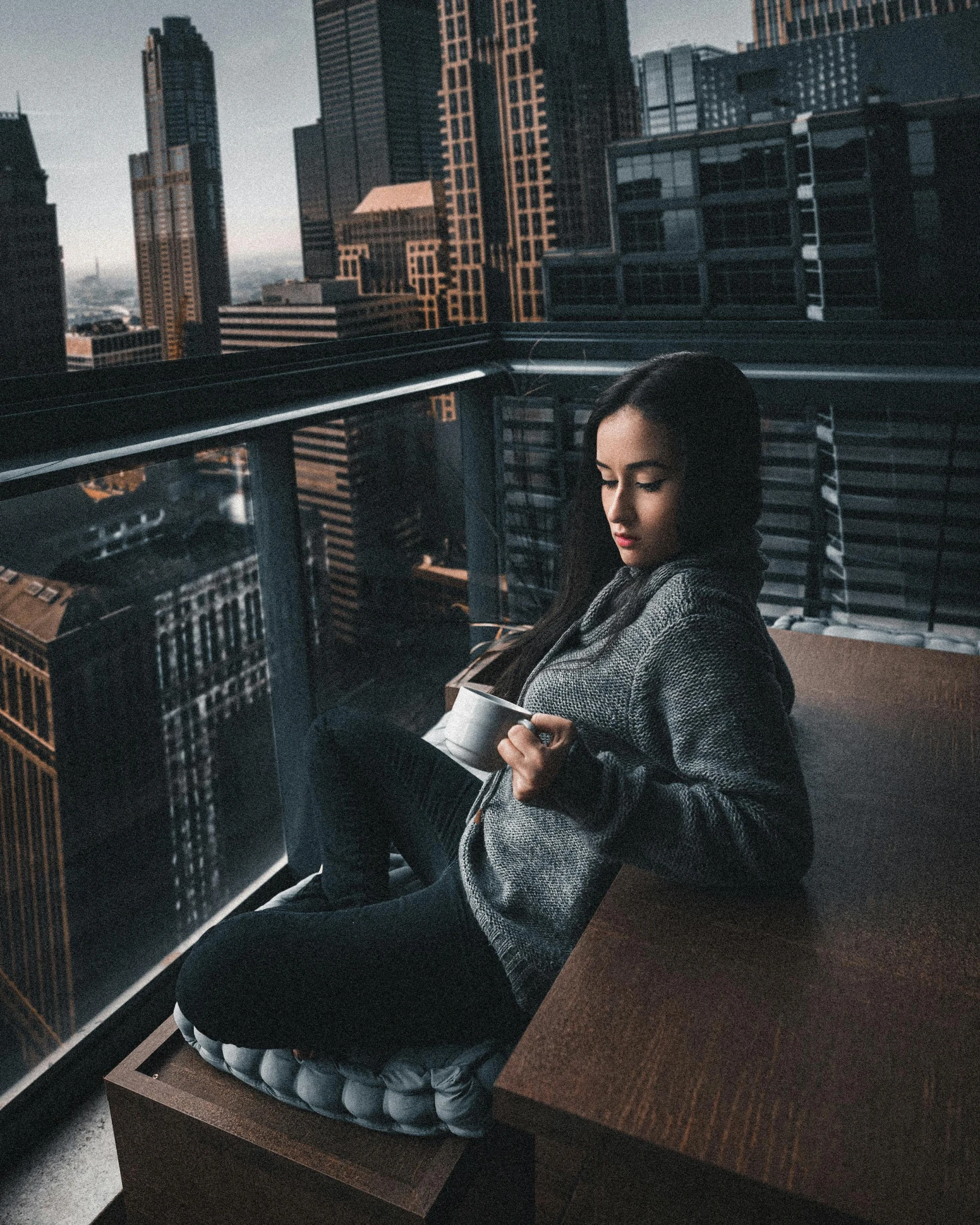 a woman sitting on a balcony with a cup of coffee, pexels contest winner, sitting on a skyscraper rooftop, portrait of vanessa morgan, gloomy mood, instagram post