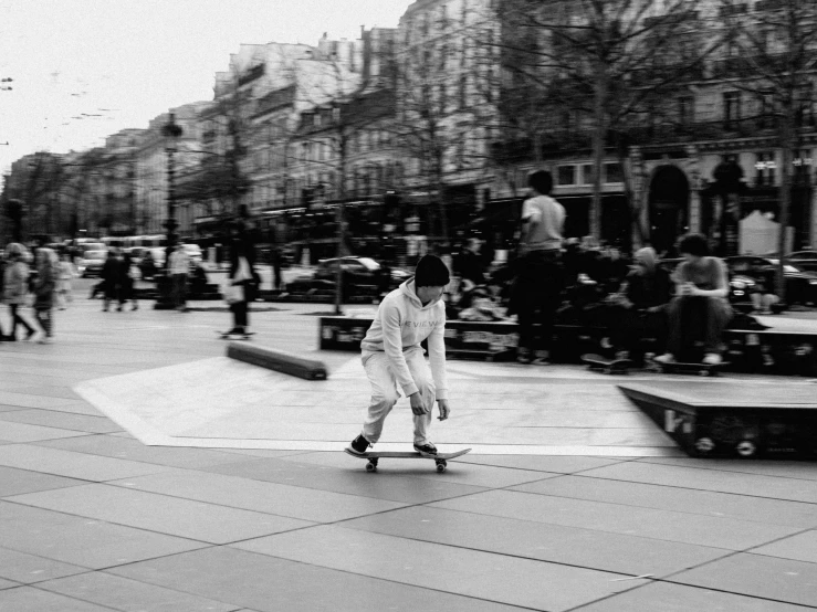 a black and white photo of a person on a skateboard, in paris, kids playing, square, low quality photo