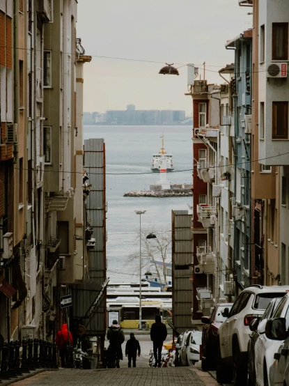 a couple of people that are walking down a street, by Ismail Acar, pexels contest winner, ships in the harbor, view from distance, slide show, floating over a city sidewalk
