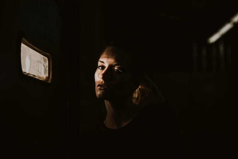 a man in the dark, a portrait, pexels contest winner, light and space, portrait of a melancholic woman, cabin lights, in the dark elevator, dramatic lighting hd quality