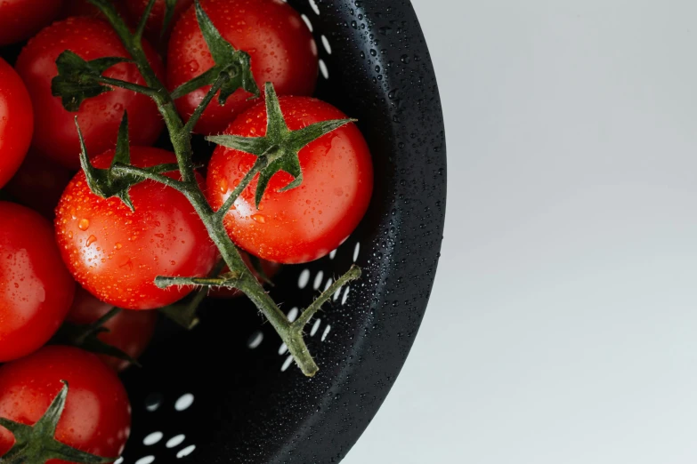 a close up of a bowl of tomatoes, by Adam Marczyński, pexels contest winner, black and red, sustainable materials, pots and pans, on clear background