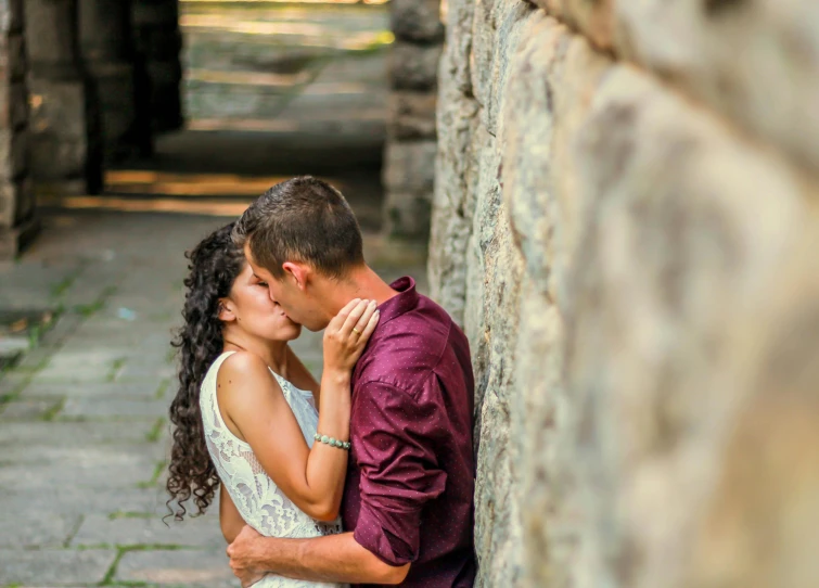 a man and a woman leaning against a stone wall, by Meredith Dillman, pexels contest winner, romanticism, kiss, 15081959 21121991 01012000 4k, rectangle, romantic lead