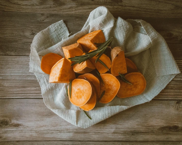 sliced sweet potatoes on a napkin on a wooden table, by Carey Morris, pexels contest winner, renaissance, thumbnail, background image, polka dot, posing