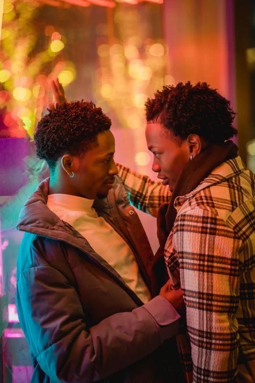 a couple of people standing next to each other, by Dorothy Bradford, trending on pexels, happening, yaoi, cinestill eastmancolor, vibrant lights, [ theatrical ]