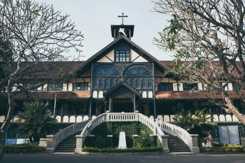 a large building with a clock on the front of it, inspired by Sydney Prior Hall, pexels contest winner, heidelberg school, south jakarta, church in the wood, 1910s architecture, exterior botanical garden