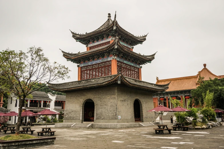 a pagoda sits in the middle of a courtyard, inspired by Wu Daozi, pexels contest winner, square, grey, sichuan, 2 0 2 2 photo