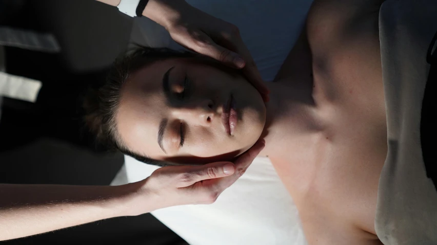 a woman getting a neck massage at a spa, a photo, by Niko Henrichon, unsplash, massurrealism, sydney hanson, coerent face and body, mid night, lying down