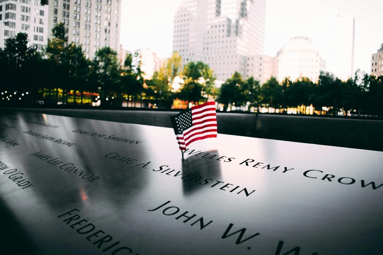 a close up of a memorial with a flag on it, pexels contest winner, manhattan, instagram post, profile image, no watermarks