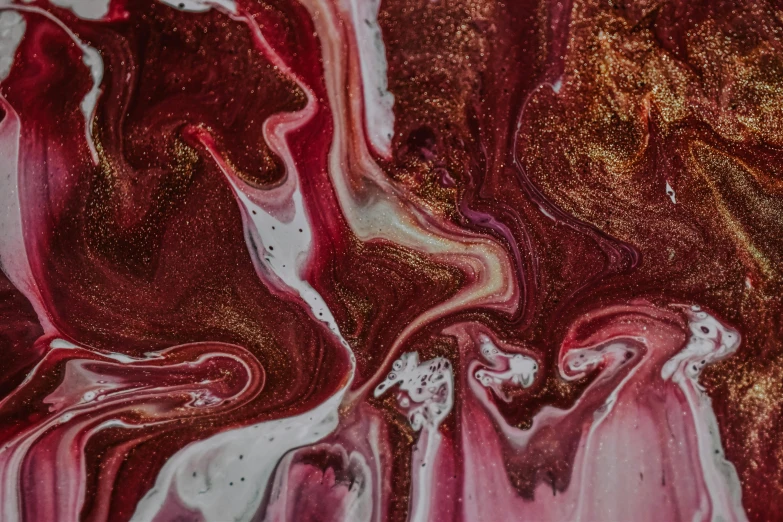 a close up of a piece of art on a table, by Sophie Pemberton, trending on pexels, abstract art, maroon metallic accents, marbled swirls, crimson and white color scheme, unknown artist